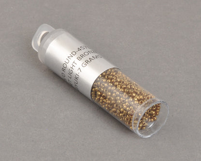 Miyuki 15/0 round seed beads in 457L metallic light bronze, 7 gram tube