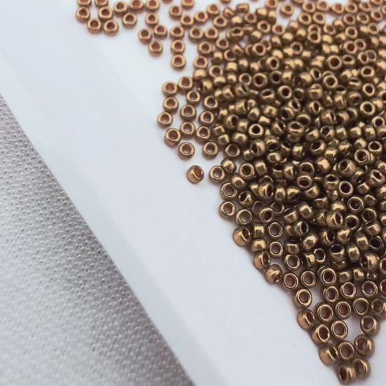 Miyuki 15/0 round seed beads in 457L metallic light bronze, 7 gram tube