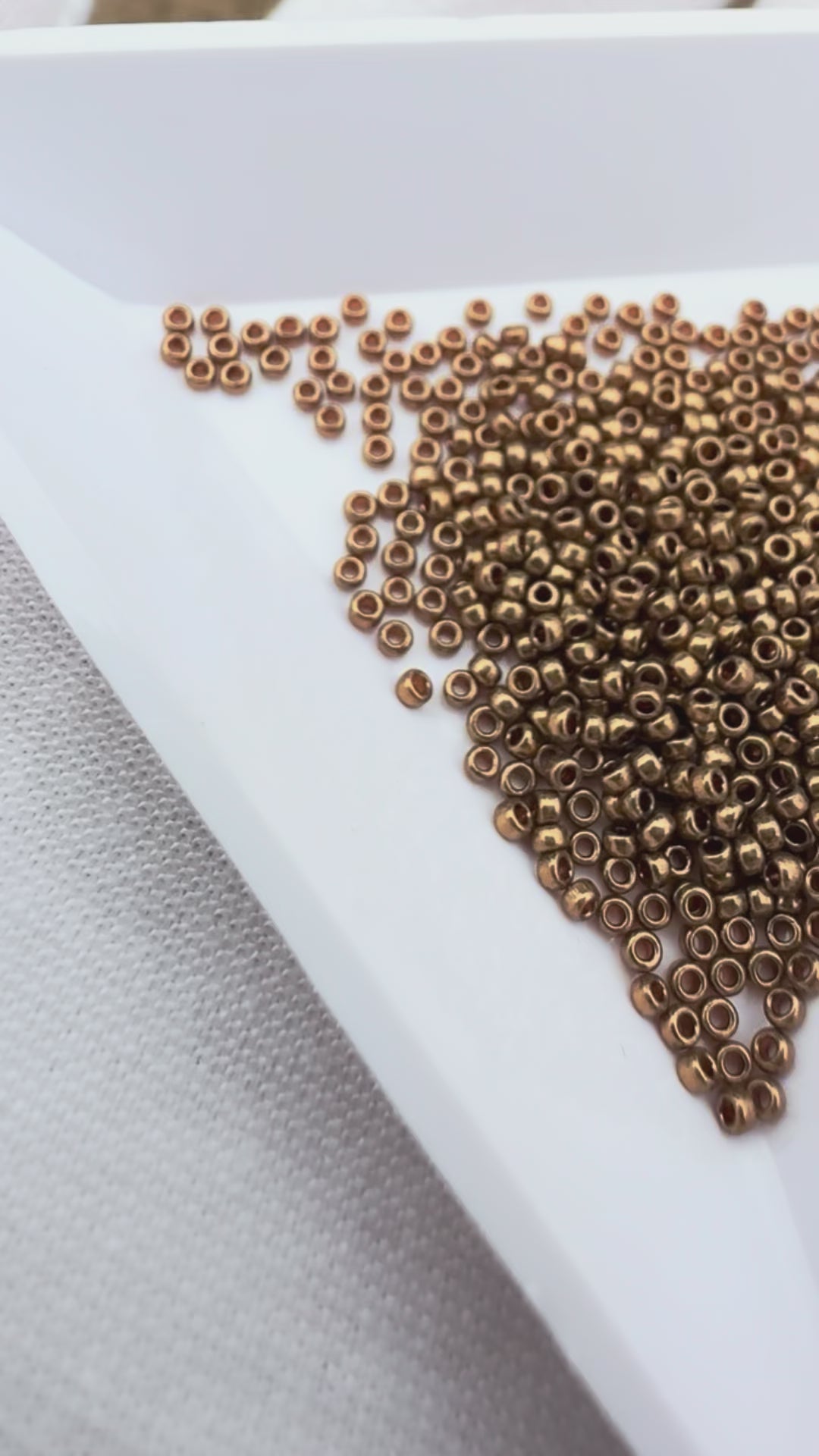 Miyuki 15/0 round seed beads in 457L metallic light bronze, 7 gram tube