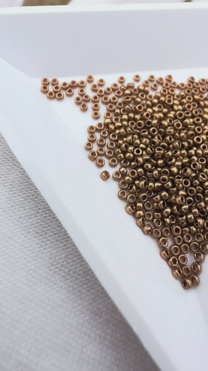 Miyuki 15/0 round seed beads in 457L metallic light bronze, 7 gram tube